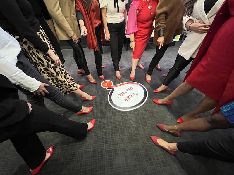 Circle of many women wearing ALLY Shoes at the experiential leadership event 2022