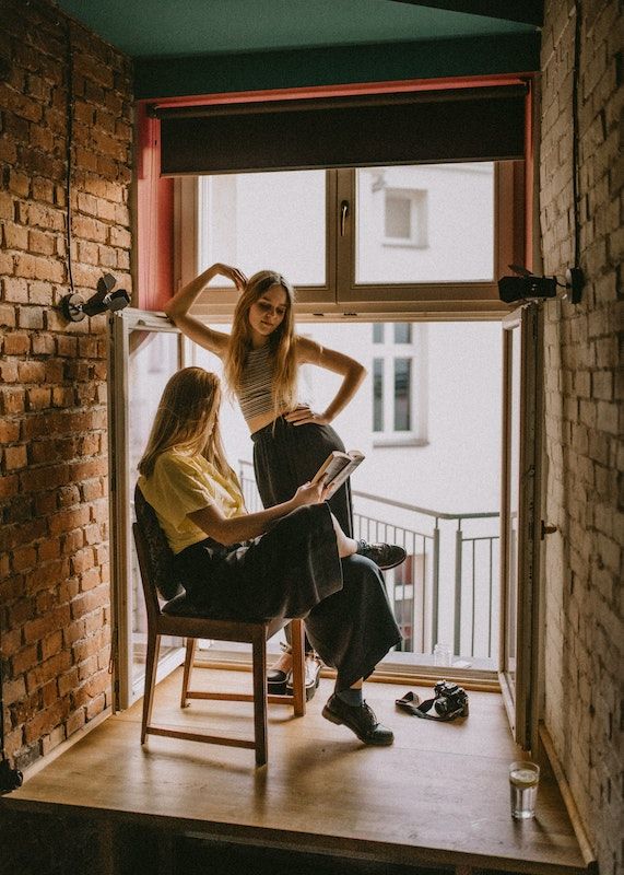 Reading out loud during the quarantine can help you spend quality time together. Photo Credit- Kinga Cichewicz. Unsplash