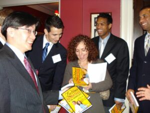 Mariela Dabbah, Hispanic Motivational Speaker, signs books at Harvard Business Club